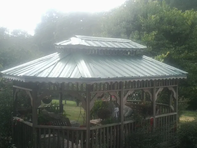 Two tier green metal roof on a garden gazebo in Sound Beach