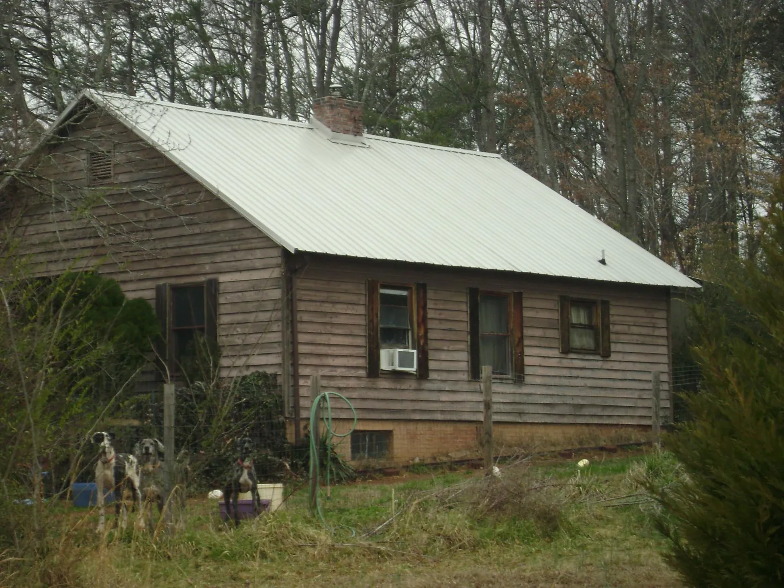 White metal roof on an old wood sided farmhouse, from a Metal Roof Installation job in Sound Beach